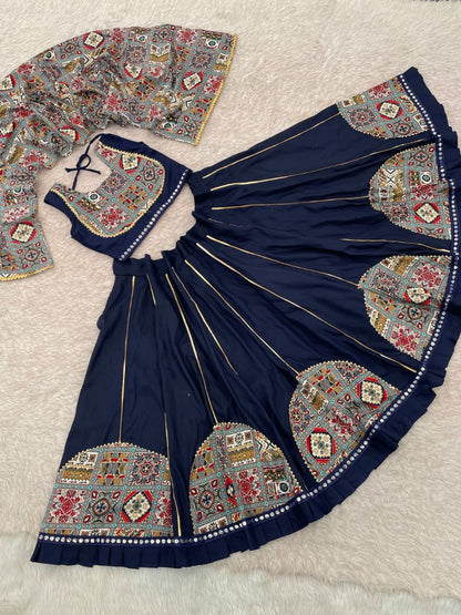 Navratri lehenga choli for your little princess. Crafted from pure rayon fabric,lehenga features beautiful patchwork and mirror work lace design